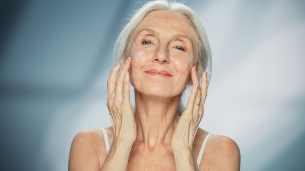 Woman applying a face mask or face cream